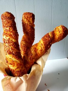 little rae's bakery cheese twists arranged in a tall container