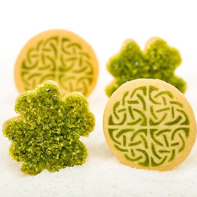 Little Rae's Celtic Knot and Lucky Clover shortbread cookies on sugar backdrop